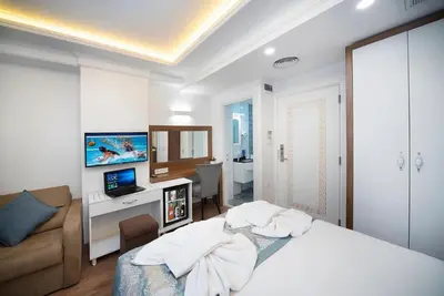 a bedroom with a bed and a living room at Lika Hotel - Beautiful Standard Double or Twin Room in Center Istanbul in Istanbul