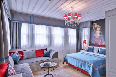 a bedroom with a bed and a couch and a chandelier at 9 Doors Hotel in Istanbul