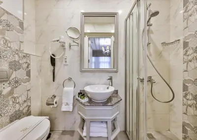 a white bathroom with a sink and a shower at 9 Doors Hotel in Istanbul