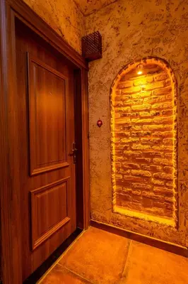 an empty room with a door and a brick wall at The First Ottoman Dream in Istanbul