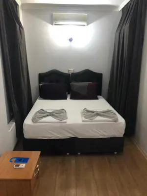 a bedroom with a bed with two pillows on it at Reydel Hotel in Istanbul