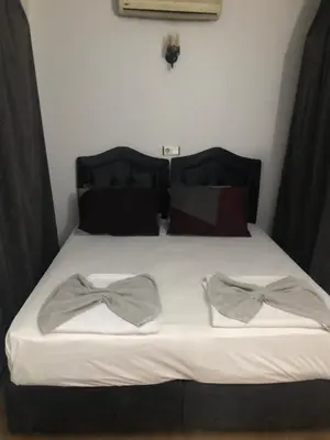 a bed with two bow ties on top of it at Reydel Hotel in Istanbul