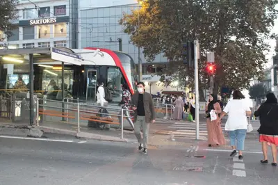 a man crossing a street in front of a bus at Hotel Falcon in Istanbul