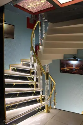 a set of stairs in a building with gold railings at Hotel Falcon in Istanbul