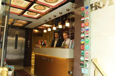 two men standing at a counter in a restaurant at Hotel Falcon in Istanbul