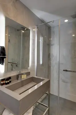 a bathroom with a sink and a shower at Pera Bosphorus Hotel in Istanbul