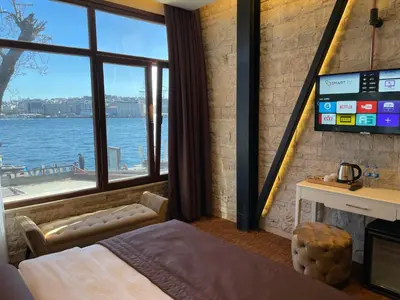a bedroom with a bed and a large window at Weingart Seaside Hotel in Istanbul