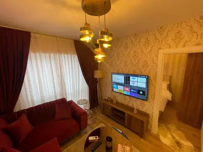 a living room with a couch and a flat screen tv at Classic Suite SS5 in Istanbul