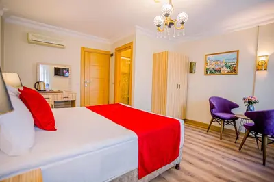 a bedroom with a bed and a table and chairs at Gülec Konak Hotel in Istanbul