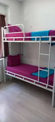 two bunk beds in a room with purple sheets at XALİLA HOSTEL & CAFE, MEN's ROOM, BEST IN ISTANBUL , in Istanbul