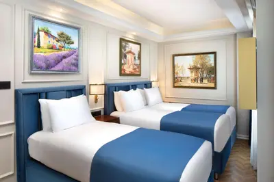 two beds in a room with paintings on the wall at Royan Hotel Hagia Sophia, a member of Radisson Individuals in Istanbul