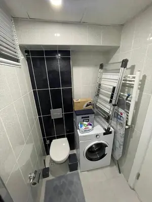 a small bathroom with a toilet and a washing machine at King Suite SS0 in Istanbul