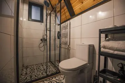 a bathroom with a shower and a toilet at Tree Bungalov Maşukiye in Kartepe