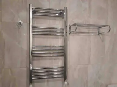 a metal towel rack in a shower in a bathroom at ViP Apartments in Çekirge