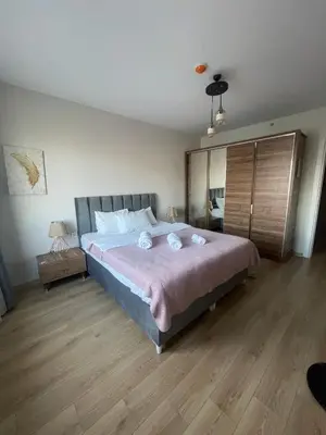 a bedroom with a large bed and a wooden floor at King Suite SS18 in Istanbul