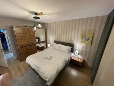 a bedroom with a large bed with white sheets at King Suite AE4 in Istanbul