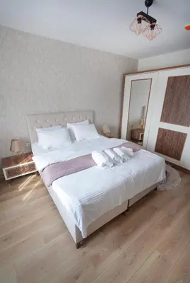 a bedroom with a large white bed with a large mirror at King Suite BH37 in Istanbul