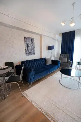 a living room with a blue couch and a table at King Suite AN9 in Istanbul