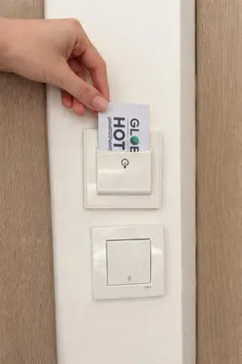 a hand is pushing a button on a lightswitch at HOTEL GLOBAL 2022 in Istanbul