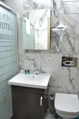 a bathroom with a sink and a toilet and a mirror at HOTEL GLOBAL 2022 in Istanbul