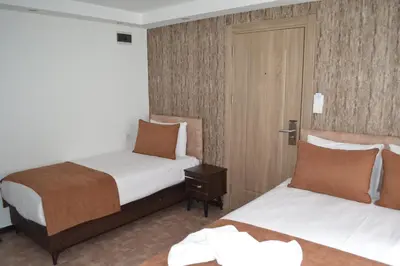 a hotel room with two beds and a door at HOTEL GLOBAL 2022 in Istanbul