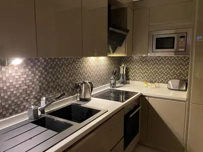 a kitchen with a sink and a microwave at The Y Istanbul Suites in Istanbul