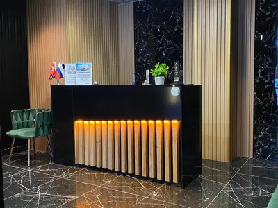 a radiator in a room with a green chair at iNALENS AİRPORT HOTEL in Arnavutköy