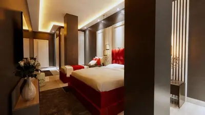 a hotel room with two beds and a couch at iNALENS AİRPORT HOTEL in Arnavutköy