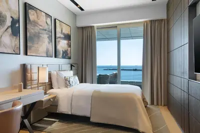 a bedroom with a bed and a desk and a window at JW Marriott Hotel Istanbul Marmara Sea in Istanbul