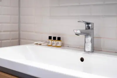 a bathroom sink with a faucet and three candles at Seven Studıos Sultanahmet in Istanbul
