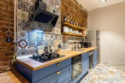 a kitchen with blue cabinets and a tile wall at Ganbaru Tours - Private Triplex&Duplex in Istanbul