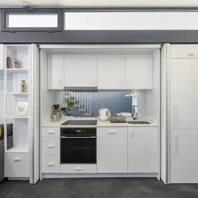 a kitchen with white cabinets and a black oven at Newly Designed Central Modern Smart Duplex! #143 in Istanbul