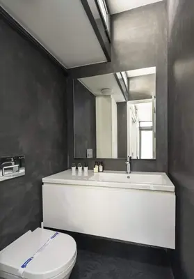 a bathroom with a tub and a toilet and a mirror at Bright Modern Design New Duplex Loft Patio! #145 in Istanbul