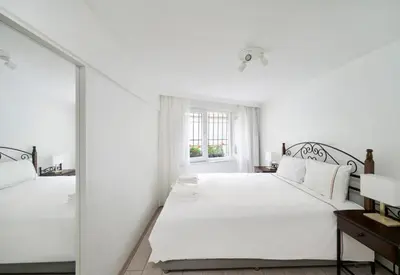 a white bedroom with a bed and a mirror at Cute Charming 1bed1bath Bebek Hidden Gem! #77 in Istanbul