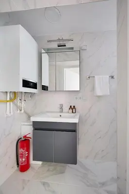 a bathroom with a sink and a red trash can at Cute Charming 1bed1bath Bebek Hidden Gem! #77 in Istanbul