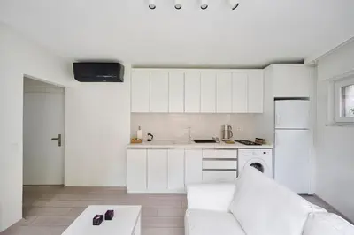 a white living room with a couch and a kitchen at Bright Modern new 1bed1bath Hidden Gem Bebek! #78 in Istanbul