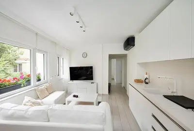 a white living room with a couch and a table at Bright Modern new 1bed1bath Hidden Gem Bebek! #78 in Istanbul
