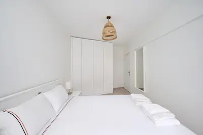 a white bedroom with a bed and a pendant light at Bright Modern new 1bed1bath Hidden Gem Bebek! #78 in Istanbul