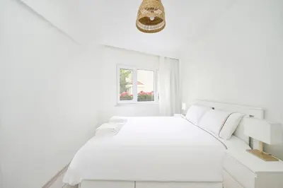 a white bedroom with a white bed and a window at Modern Bright Cozy 1bed1bath Hidden Gem! #79 in Istanbul