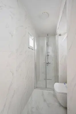 a white bathroom with a shower and a toilet at Modern Bright Cozy 1bed1bath Hidden Gem! #79 in Istanbul