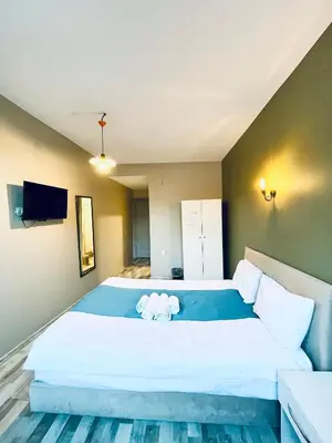 a bedroom with a large bed with two stuffed animals on it at Puffin Boutique - Istanbul in Istanbul