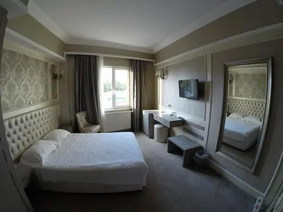 a hotel room with a bed and a mirror at deniz otel in Istanbul