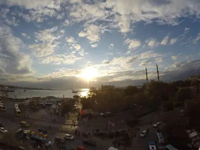a view of a city with the sun in the sky at deniz otel in Istanbul