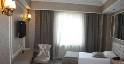 a hotel room with a bed and a window at deniz otel in Istanbul