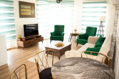 a living room with green chairs and a couch at King Suite WH32 in Istanbul