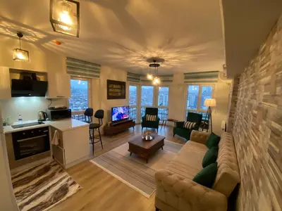 a living room with a couch and a table and a kitchen at King Suite WH32 in Istanbul