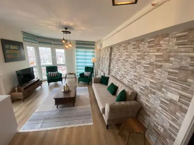 a living room with a couch and a brick wall at King Suite WH32 in Istanbul