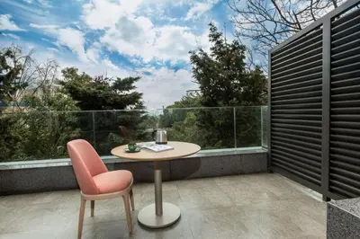 a table and two chairs on a balcony with a view at Radisson Hotel Istanbul Harbiye in Istanbul