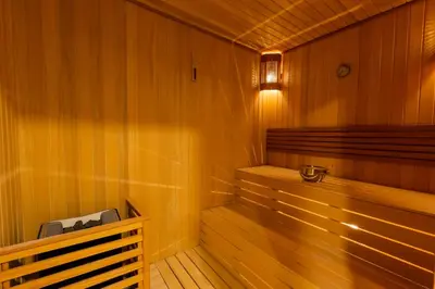 a sauna with a bench in a wooden room at Radisson Hotel Istanbul Harbiye in Istanbul