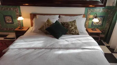 a bedroom with a large white bed with pillows at Nevalist Hotel in Istanbul